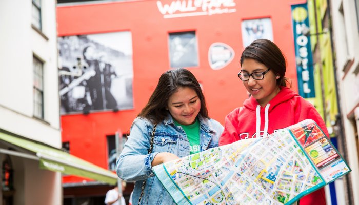 Two visitors reading a city map in Temple Bar, Dublin.